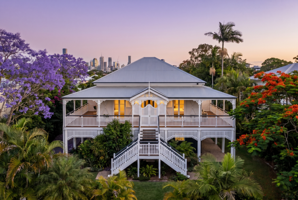 Queenslander home at dusk with warm lit windows